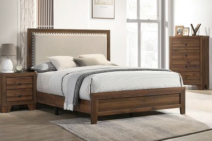 Brown wood bed with upholstered nailhead headboard