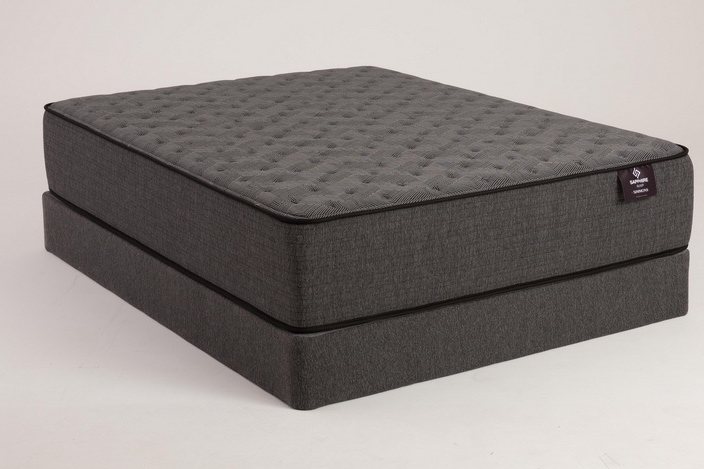 Firm gray mattress on a matching base