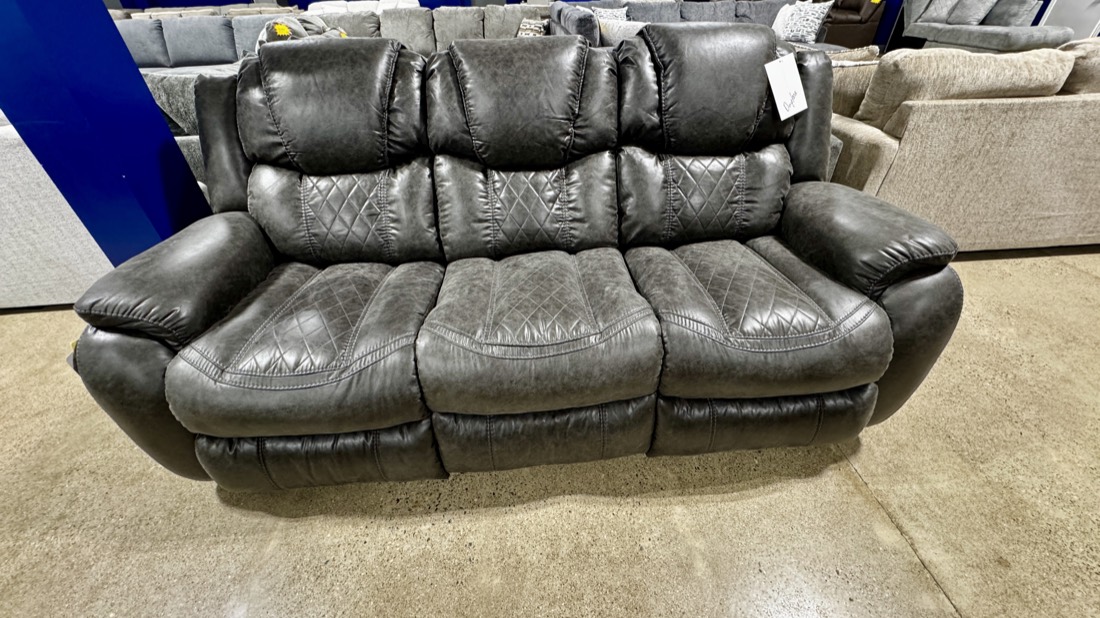 Gray manual reclining sofa, brand new on the BoxDrop showroom floor